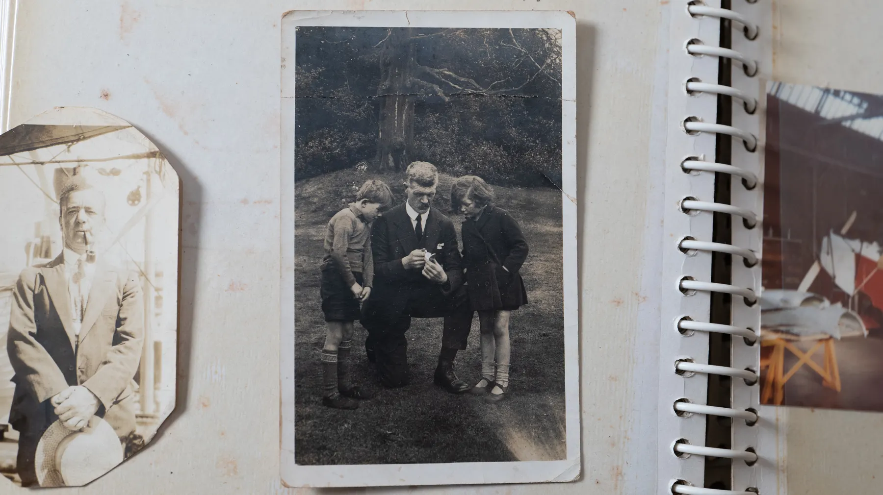 Loose sepia photographs laid out on a wooden table